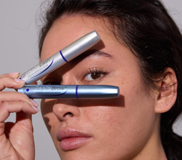 Woman holding RapidLash and RapidBrow serum tubes near her face