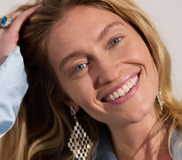 Smiling woman in a light blue beauty campaign portrait