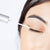 Model applying RapidLash® on eyelash