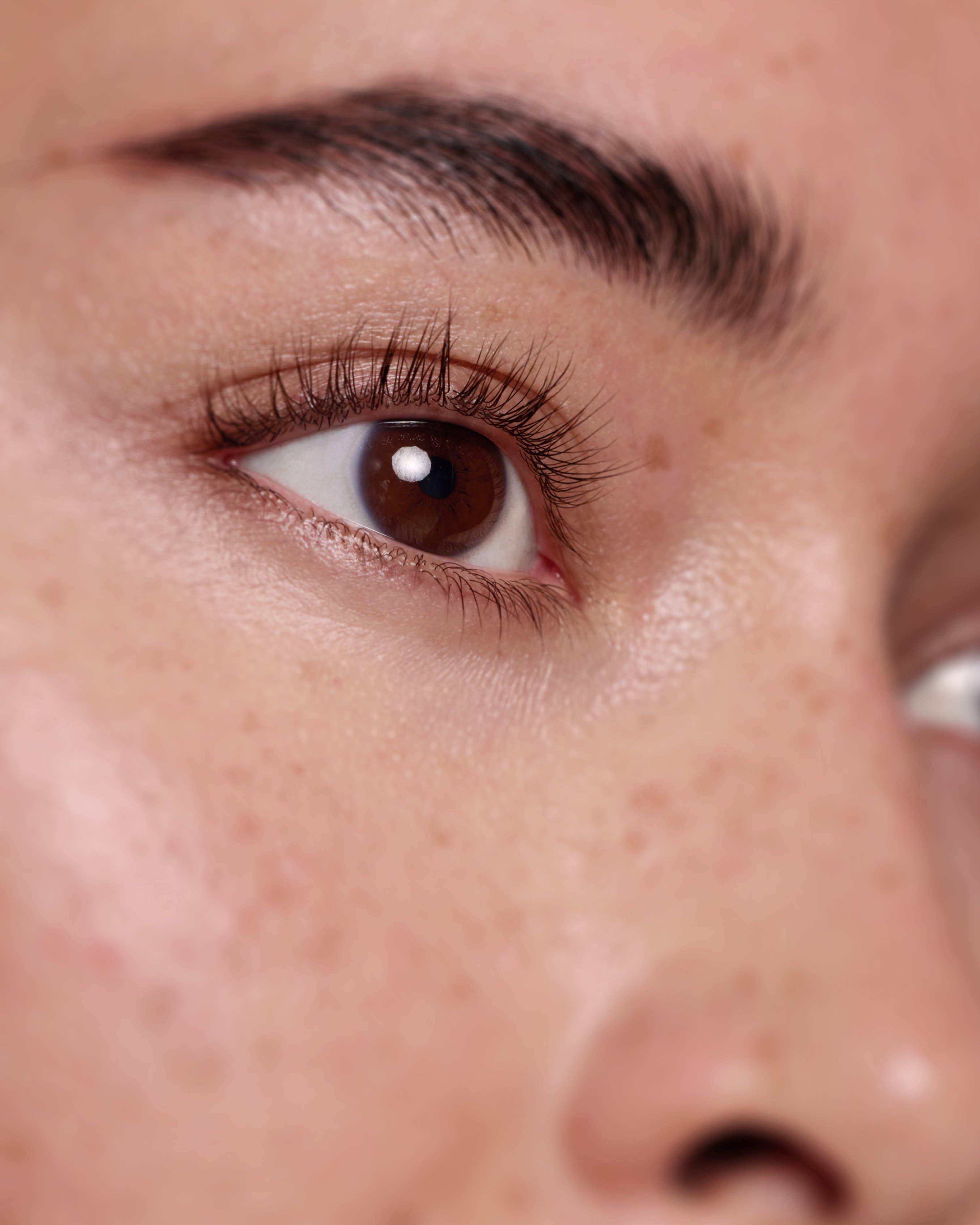Woman applying RapidLash along her upper lash line