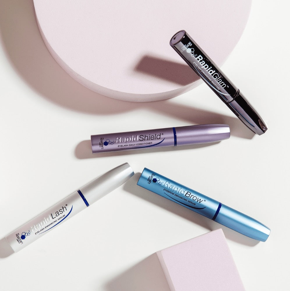 RapidGlam™, RapidShield®, RapidBrow®, and RapidLash® products lying on a white background